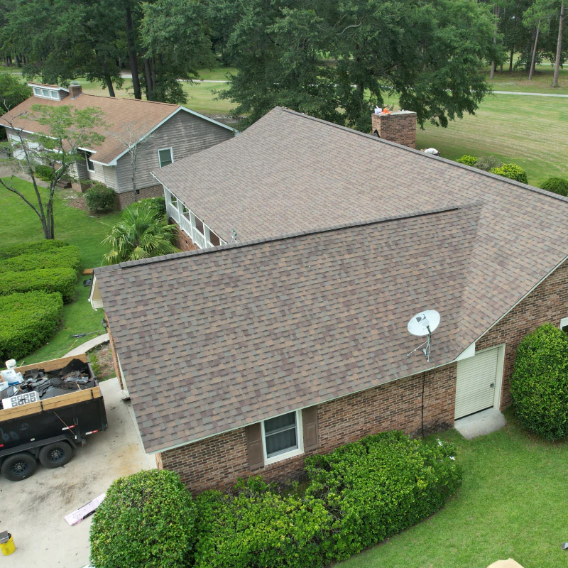 an aerial view of a a newly installed roof shingles
